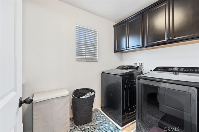 laundry area featuring cabinets and independent washer and dryer