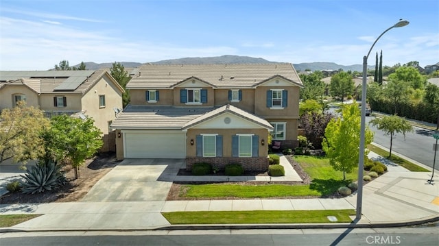 view of front of home with a mountain view and a garage