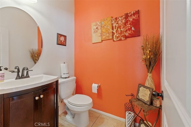 bathroom featuring tile patterned flooring, vanity, and toilet