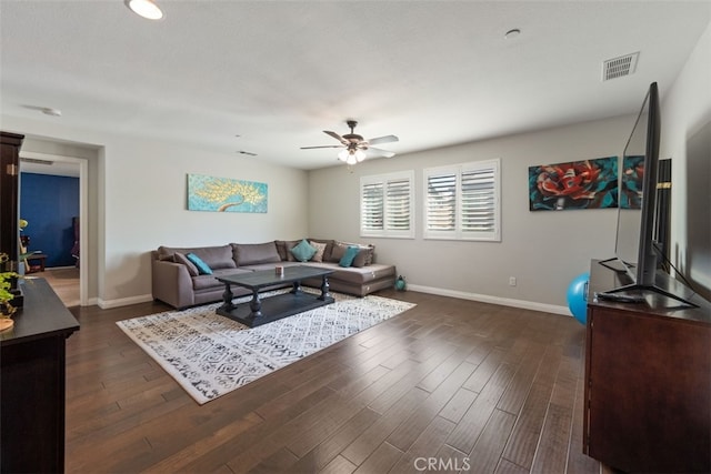 living room featuring dark hardwood / wood-style flooring and ceiling fan