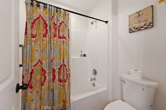 bathroom with shower / bath combo and toilet