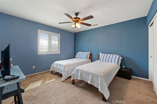 bedroom with carpet flooring, ceiling fan, and a closet