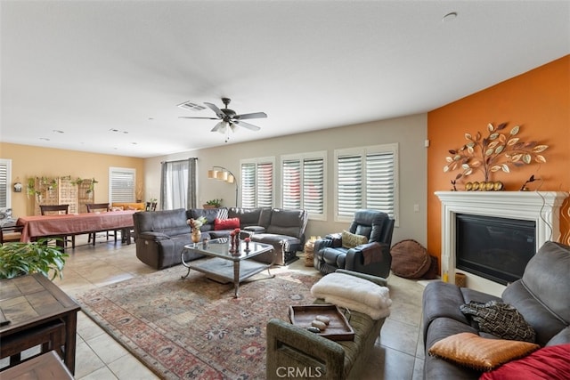 living room featuring ceiling fan and light tile patterned floors