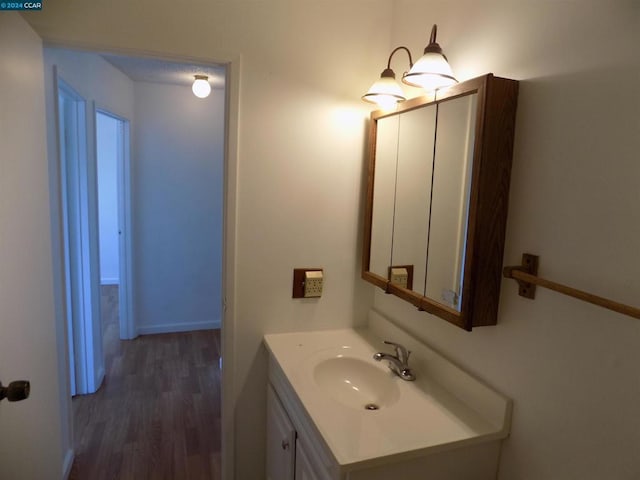 bathroom featuring hardwood / wood-style floors and vanity