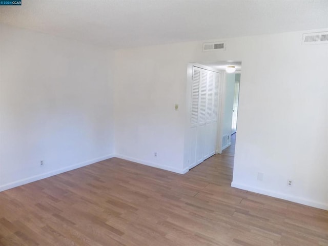 spare room featuring light hardwood / wood-style flooring