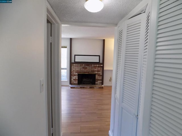 hallway featuring a textured ceiling and hardwood / wood-style flooring