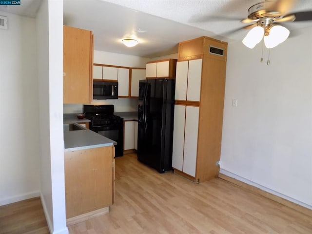 kitchen with ceiling fan, white cabinets, black appliances, and light wood-type flooring