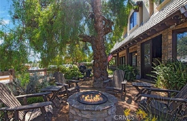 view of patio with a fire pit