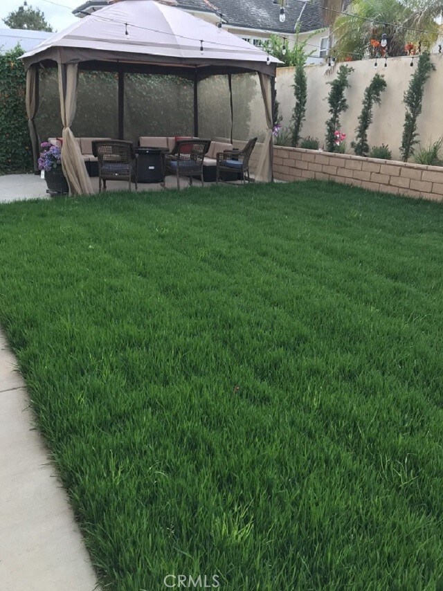 view of yard with a gazebo, a patio area, and an outdoor living space