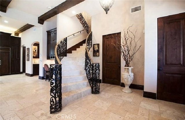 foyer featuring beamed ceiling