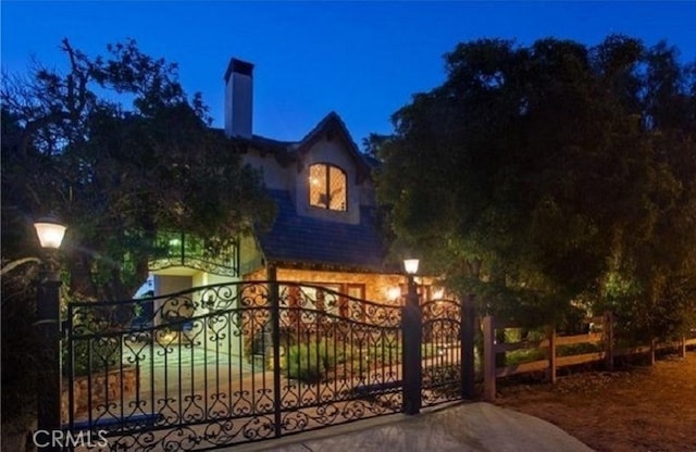 view of gate at twilight