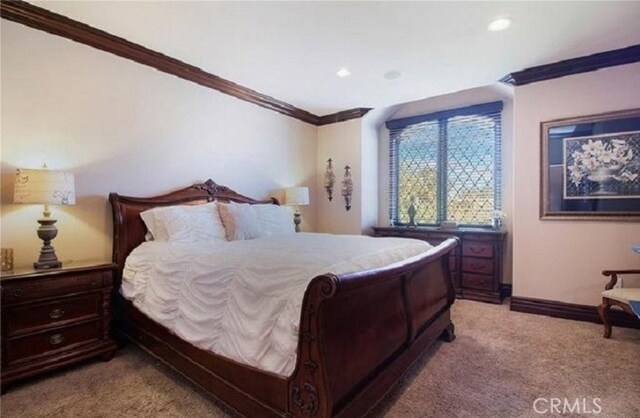 bedroom with light colored carpet and ornamental molding