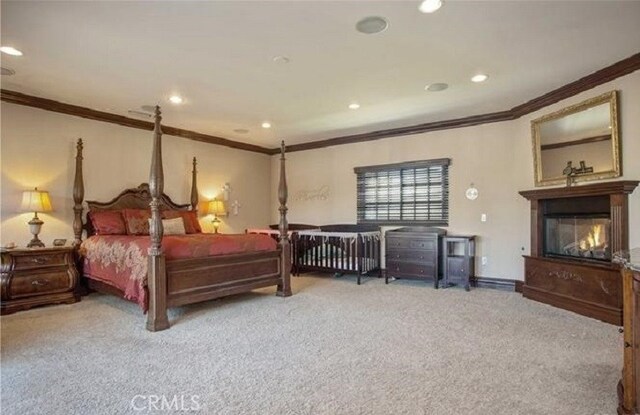 carpeted bedroom with crown molding