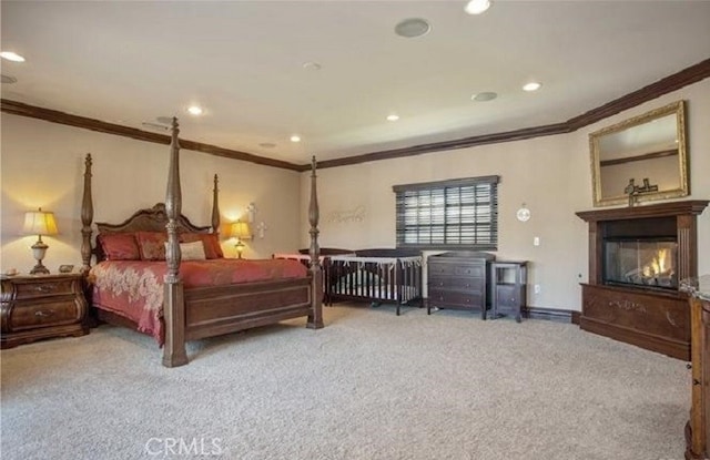 bedroom featuring crown molding and carpet