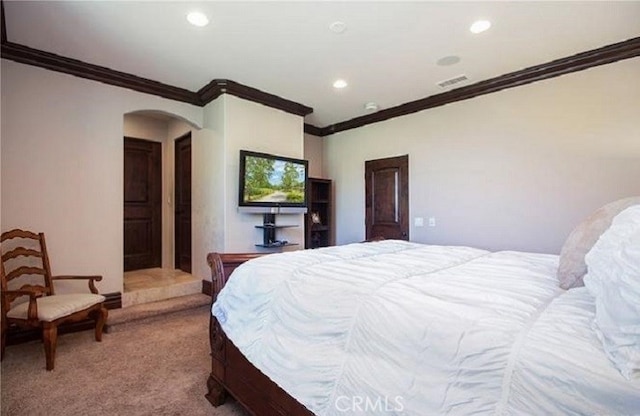 bedroom featuring crown molding and carpet