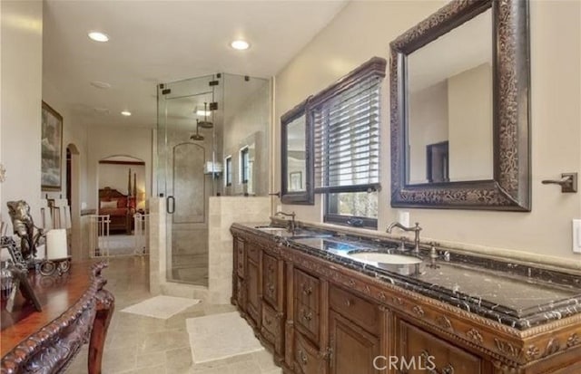 bathroom with vanity and a shower with shower door