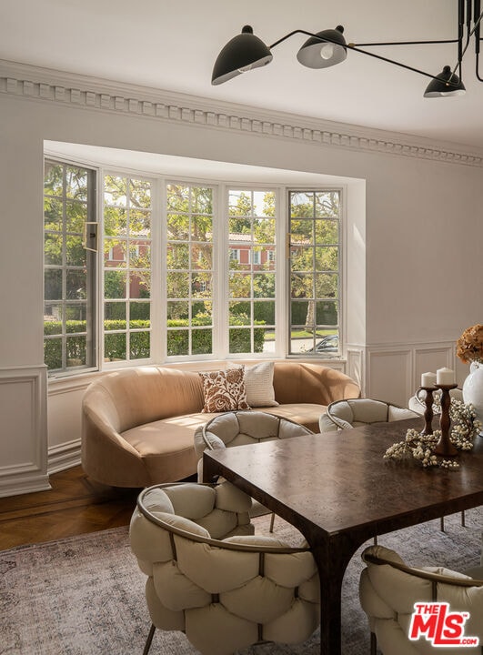 living room featuring crown molding, hardwood / wood-style floors, and a wealth of natural light