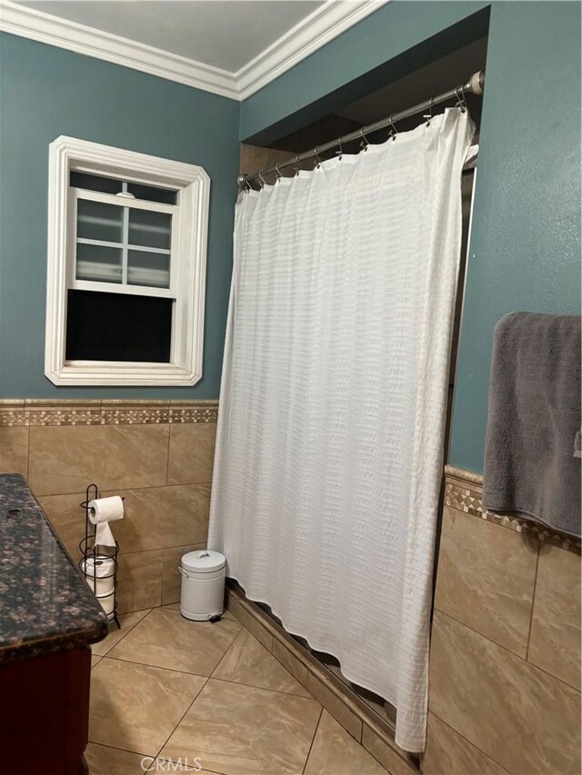 2407 E Bliss St, Compton, CA 90222 - bathroom featuring tile walls, vanity, a wainscoted wall, ornamental molding, and tile patterned floors