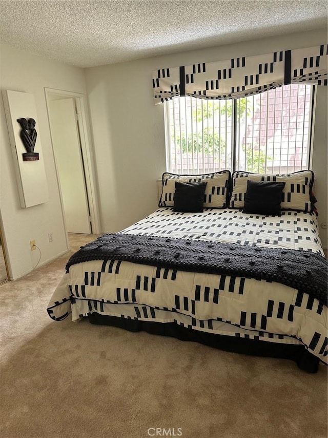 bedroom featuring carpet floors and a textured ceiling