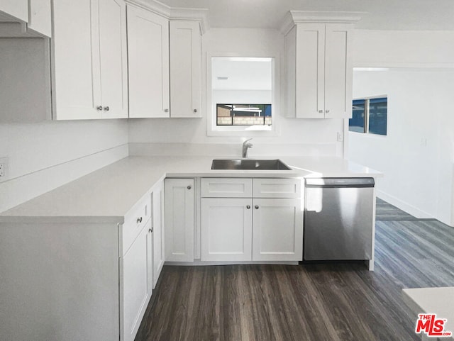 kitchen with dark wood-type flooring, sink, white cabinets, and stainless steel dishwasher