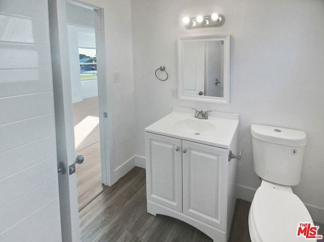 bathroom featuring vanity, toilet, and wood-type flooring