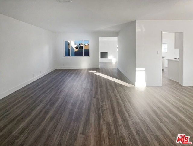 unfurnished room with a healthy amount of sunlight and dark hardwood / wood-style floors