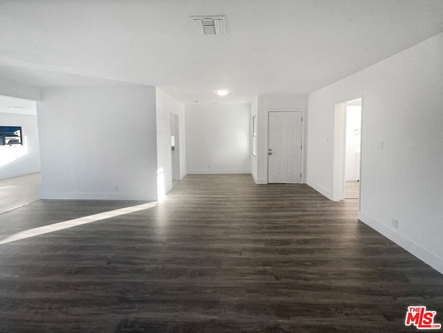 unfurnished room with dark hardwood / wood-style floors