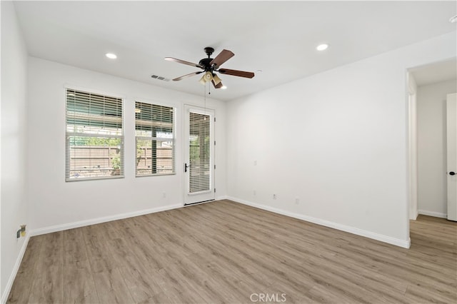 unfurnished room with ceiling fan and light hardwood / wood-style flooring