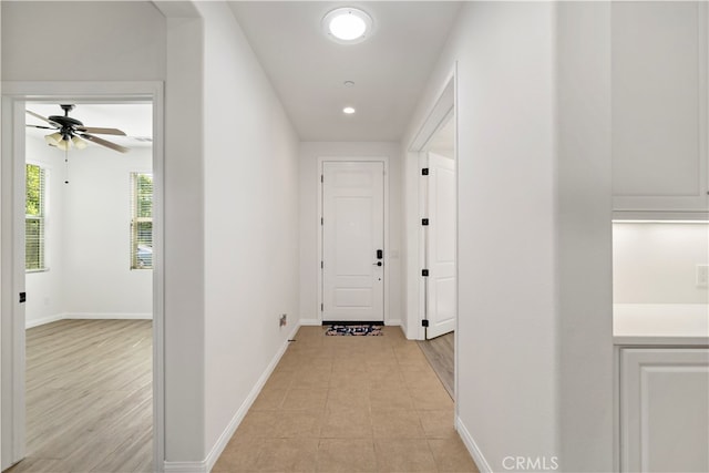 corridor with light hardwood / wood-style floors