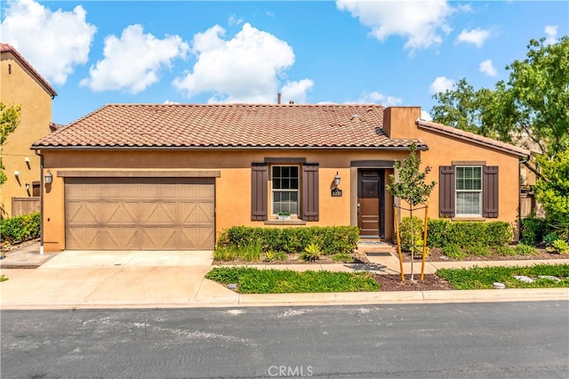 mediterranean / spanish-style home with a garage