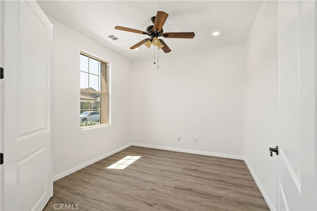 spare room featuring ceiling fan and light wood-type flooring