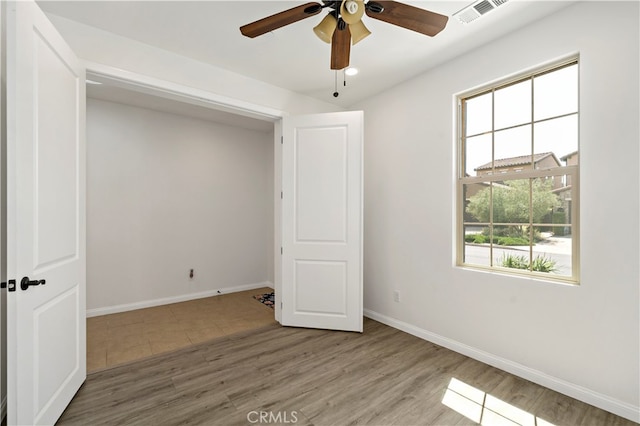 unfurnished bedroom featuring hardwood / wood-style floors and ceiling fan