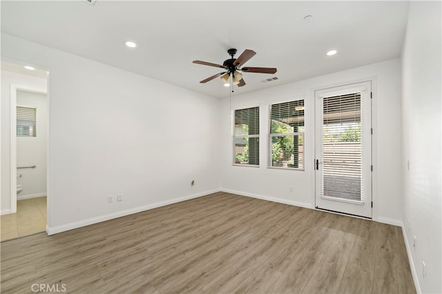 spare room featuring light wood-type flooring and ceiling fan