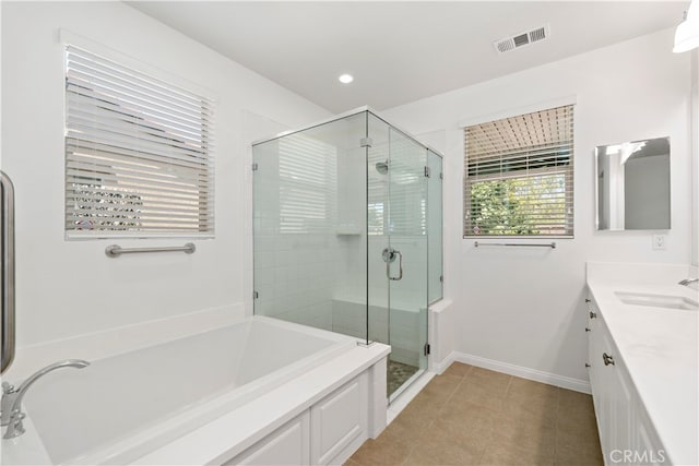 bathroom with vanity, plus walk in shower, and tile patterned flooring