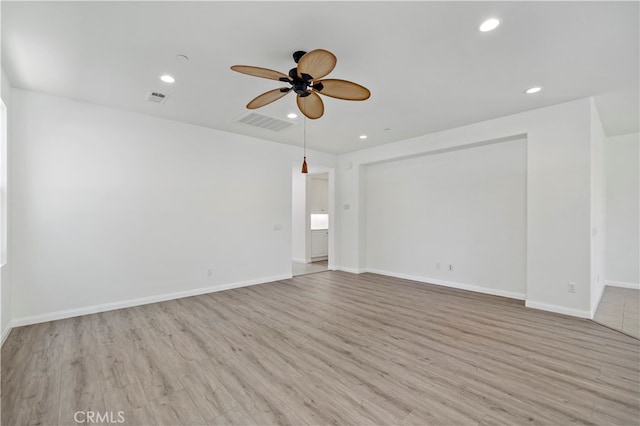 empty room featuring light wood-type flooring and ceiling fan