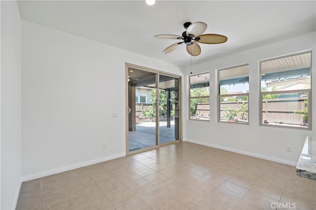 spare room with light tile patterned flooring and ceiling fan