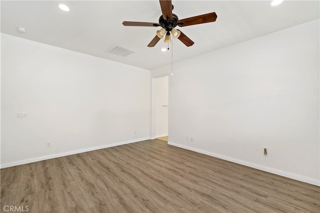 empty room with ceiling fan and hardwood / wood-style floors