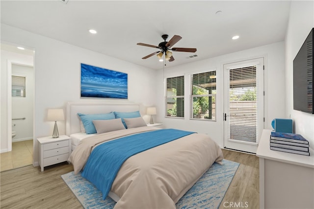 bedroom featuring access to outside, light hardwood / wood-style flooring, ensuite bath, and ceiling fan