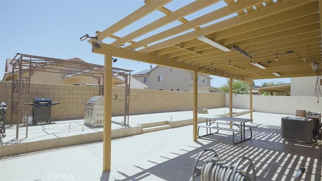 snow covered patio featuring a grill, a pergola, and central AC