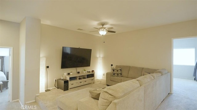 carpeted living room featuring ceiling fan