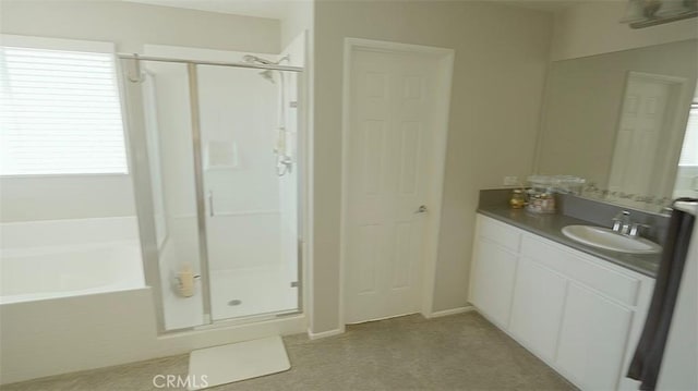 bathroom with vanity and independent shower and bath