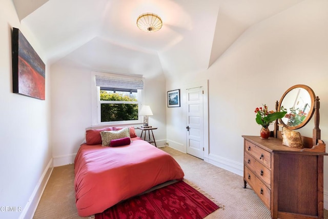 carpeted bedroom featuring lofted ceiling