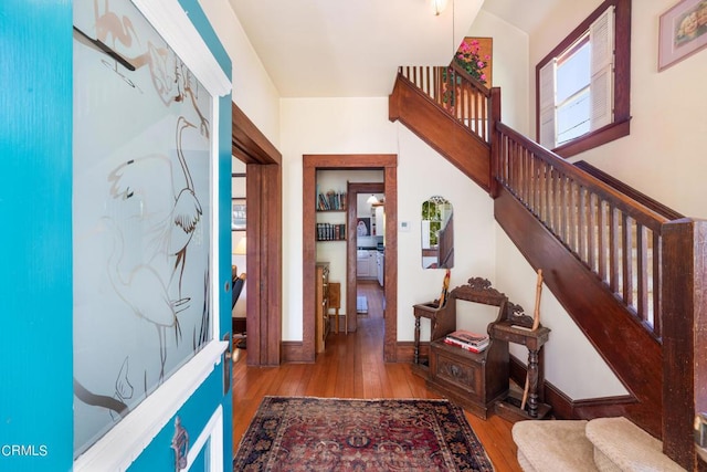 entrance foyer with light hardwood / wood-style floors and vaulted ceiling