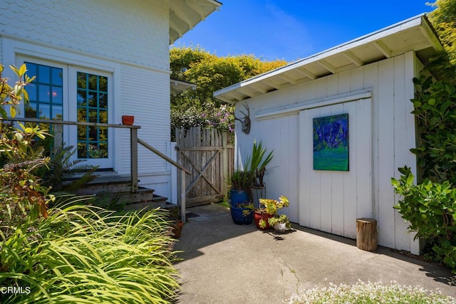 view of exterior entry featuring a patio area