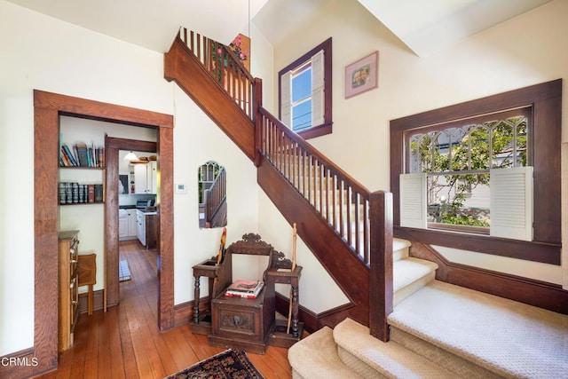 stairs with hardwood / wood-style floors