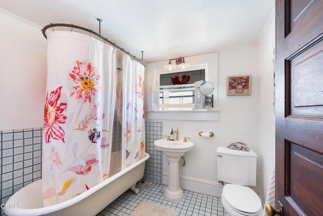 bathroom featuring tile patterned flooring, toilet, shower / bath combo with shower curtain, and tile walls