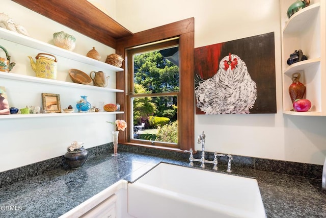 interior space featuring white cabinets and sink