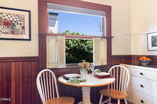 dining area featuring wood walls