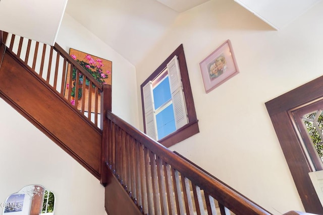 stairs with vaulted ceiling