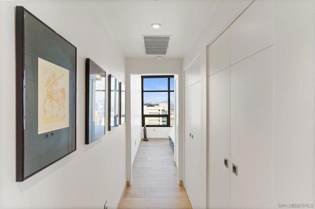 hall with light wood-type flooring